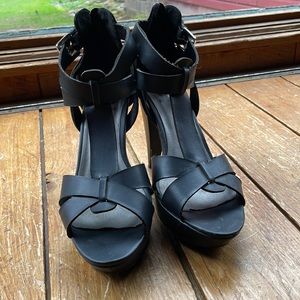 Black straps high heeled sandals.
